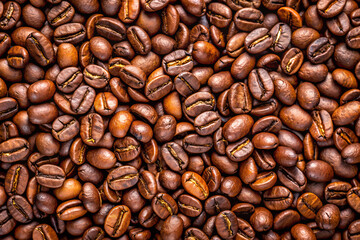 Diverse shades of brown, densely packed roasted coffee beans, background