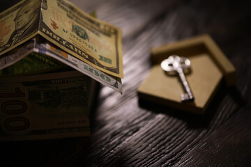 Money house on wooden table, close up