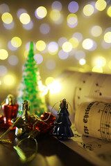 Christmas decorations on music sheets, closeup