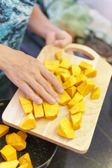 Cooking fresh yellow pumpkin in a kitchen - 789201109