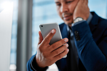 Hand, phone and text message with business man in office for communication, networking or problem solving. App, contact and social media with corporate employee reading info at desk in workplace