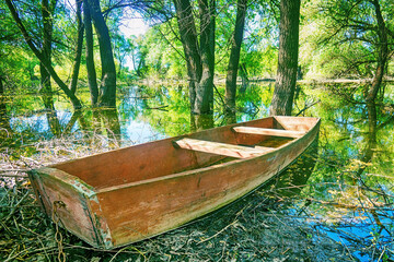 Old simple wooden one oar flat-bottomed boat design for inland waters. It resembles coffin and in...