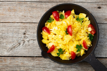 Healthy vegetarian breakfast . Scrambled eggs toast with cherry tomatoes and parsley