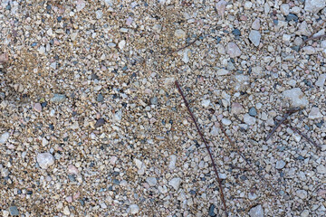the texture of the riverbank with a rocky fraction and a sand-gravel mixture, a background for designers