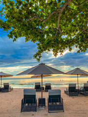 gazebo and chair at beach against blue sky