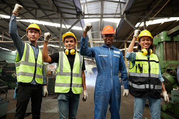 workers or engineers raise hands for success work and project in the factory