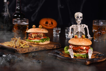  A Monster Burger on a sitting skeleton in the fog will definitely lift the spirits and is the perfect Halloween party appetizer. - obrazy, fototapety, plakaty