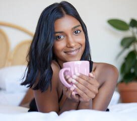 Breakfast, bed and Indian woman with coffee, portrait and smile in morning, relax and happiness in...