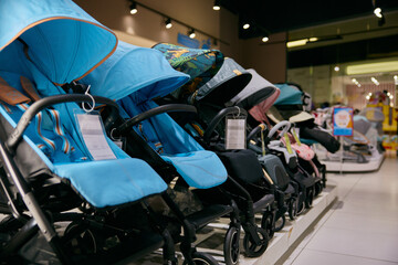 Variety of baby carriages and strollers in row at in newborn kids section - 789226539
