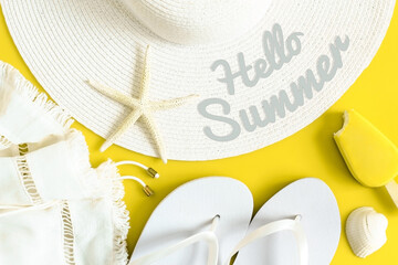 Hello summer text on sun hat, flip flops, ice cream and shells. Summertime, vacation, travel, tourism, seasonal concept. Yellow and white colors. Top view. - obrazy, fototapety, plakaty