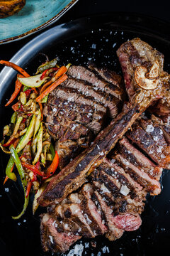 Perfectly cooked T-bone steak with sauteed vegetables