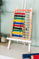abacus calculating with beads on wooden rainbow abacus for number calculation. Mathematics learning concept