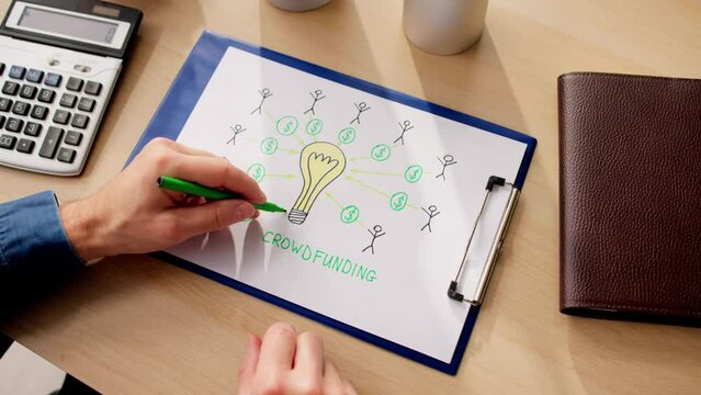 Businessperson Drawing Crowdfunding Concept On Paper