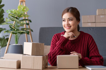 SME business entrepreneurs small in asia Preparing cardboard boxes in home office Small business operators preparing to ship to customers