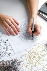 Astrology. Astrologer calculates natal chart and makes a forecast of fate Tarot cards, Fortune...