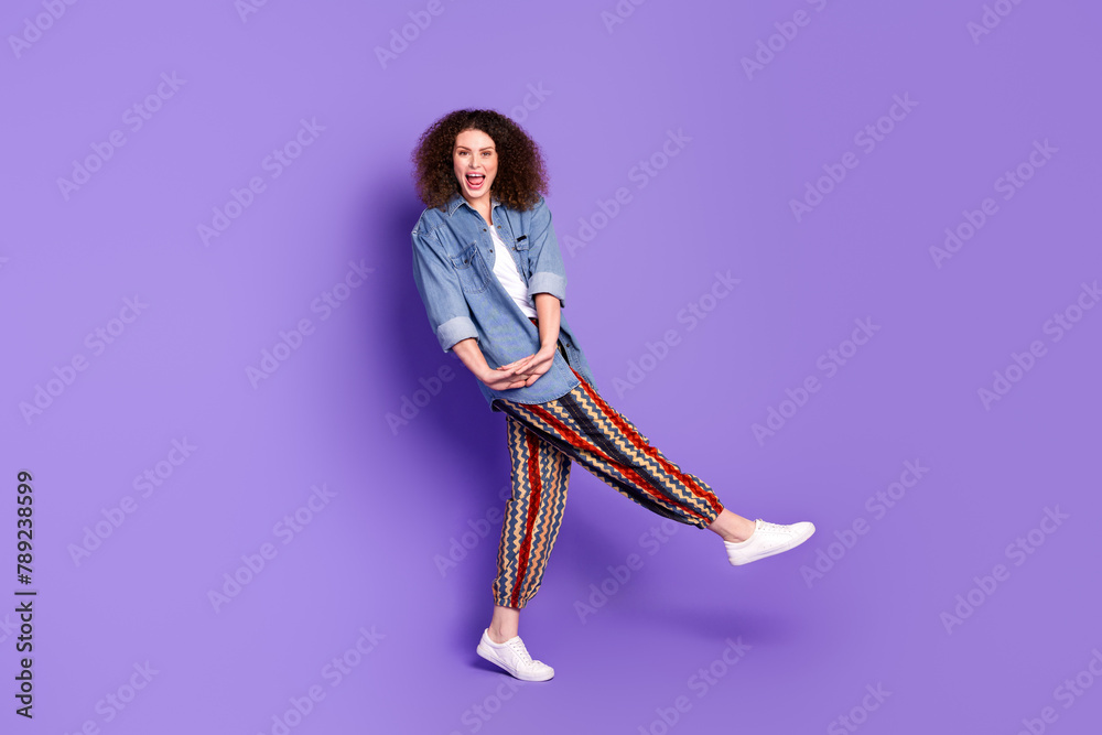 Wall mural Full size photo of cool nice girl have fun dancing wear denim shirt isolated on violet color background