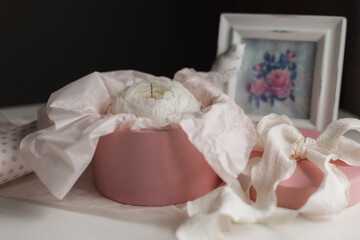 handmade candle in the shape of a flower in a gift box