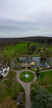 Huizingen, Belgium, 26th of March, 2024, This image offers an aerial perspective of the Huizingen Domain, a grand estate in Belgium, set against a backdrop of expansive gardens and wooded areas. The