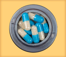 Pile of blue prescription drugs pills in open container - 789241394