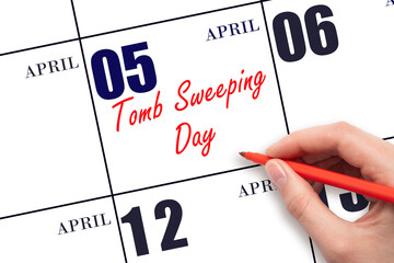 April 5. Hand writing text Tomb Sweeping Day on calendar date. Save the date.