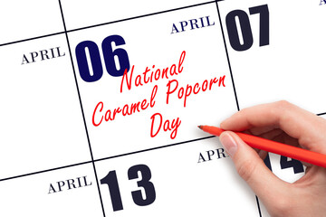 April 6. Hand writing text National Caramel Popcorn Day on calendar date. Save the date.