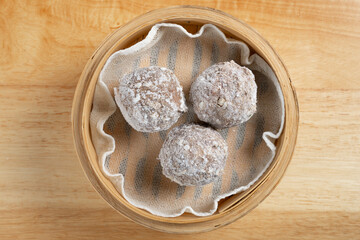 top view raw frozen beef balls in bamboo steamer