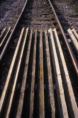 Fototapeta na wymiar Vertical image of railway tracks at Woodbridge Rail Station Suffolk UK in 2003. Closeup view. 