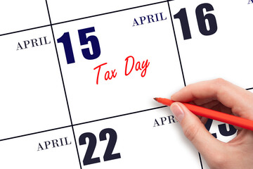 April 15. Hand writing text Tax Day on calendar date. Save the date.