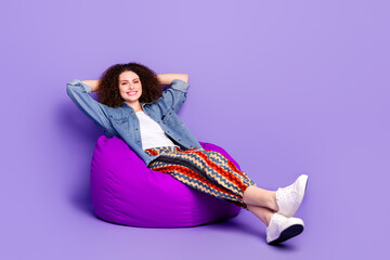 Full size photo of cool nice girl sit cozy bag wear denim shirt isolated on violet color background