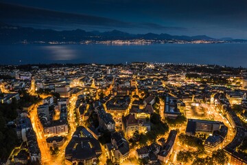 Dusk Delights: Aerial Hyperlapse of Lausanne Cityscape with Lake Geneva in Full 4K image