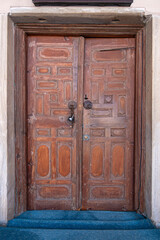 Fototapeta na wymiar Traditional Ottoman Houses and historical inn doors in Manisa. Kula is on the UNESCO World Heritage List. Old wooden mansions Turkish architecture. Kula historical wooden and metal doors.