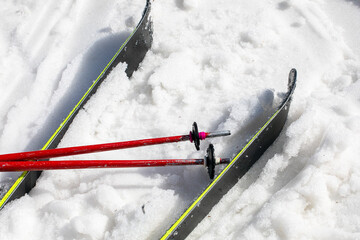 ski poles and skis on a snowy slope on a sunny day