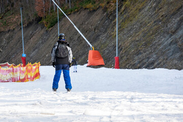 skiers on a snow slope for beginners on a sunny day. active recreation