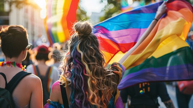 People take part in the gay pride parade with a lgbt flag