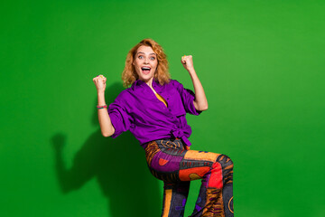 Photo portrait of pretty young girl raise fists win lottery wear trendy purple outfit isolated on...
