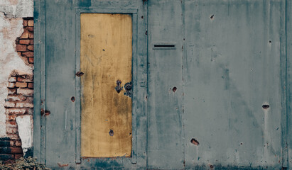 damaged blue yellow house wall war in Ukraine