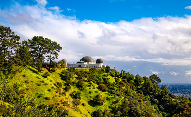 Panoramic view of popular historic oberservatory in Los Angeles, California (USA) on a sunny spring day. Monument, sight and major tourist attraction in the Hollywood Hills in Griffith Park park.