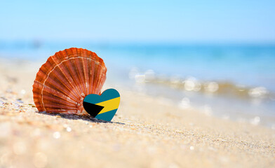Sandy beach in Bahamas. Flag of the Bahamas in the shape of a heart and a large shell. A wonderful...