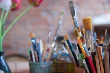  Art and craft tools close up view .   Colorful array of paintbrushes and paints