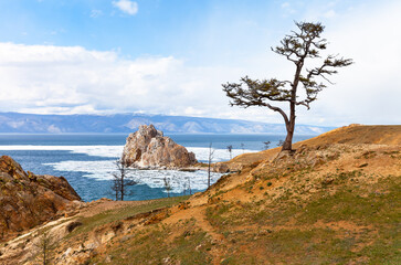 Spring landscape of Baikal Lake. Famous Shamanka Rock is natural landmark and place of attraction for tourists on Olkhon Island. Ice floes melting near Burkhan Cape. Natural seasonal background