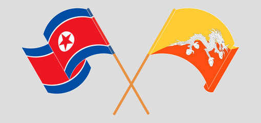Crossed and waving flags of North Korea and Bhutan