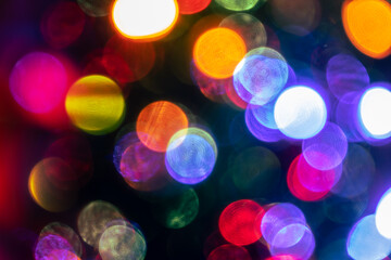Shimmering abstract colored circles defocused christmas lights background. Blurred fairy lights....