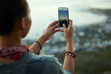 Woman, smartphone and picture on mountain for social media, sunset and adventure for holiday....