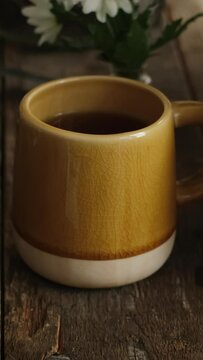 Vertical video. Tea party. Female hands pour sugar into tea mug and stirs It.