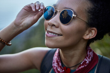 Travel, happy woman and sunglasses in nature for hiking in morning, adventure or explore outdoor....