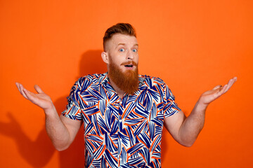 Photo of impressed amazed guy dressed print shirt open mouth rising arms isolated orange color background