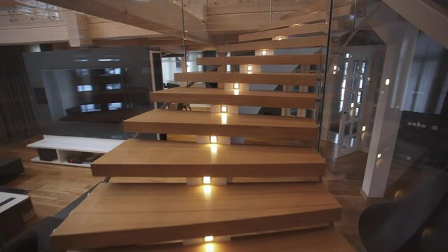up a wooden staircase with a light