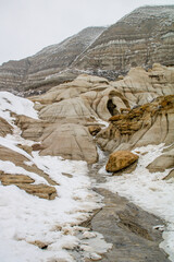 Winter clings to the hoodoos as spring arrives in the badlands. Drumheller Alberta, Canada.