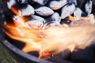 Barbecue briquette background. Setting fire to coal. Blowing flame to light up the bbq. Perfect...