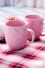 Obraz na płótnie Canvas Mugs with tartan patterns, pink christmas сreated with Generative Ai